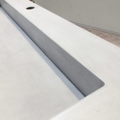 Ramped vanity slot drain